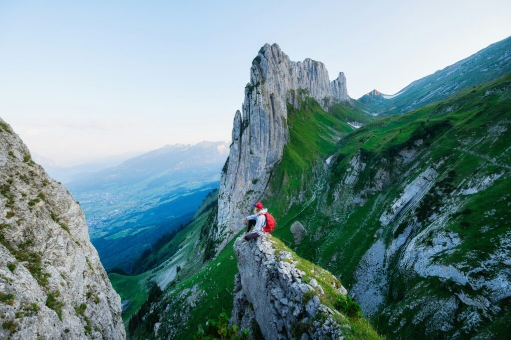 Tourist on the high rocks background. Sport and active life concept. Adventure and travel